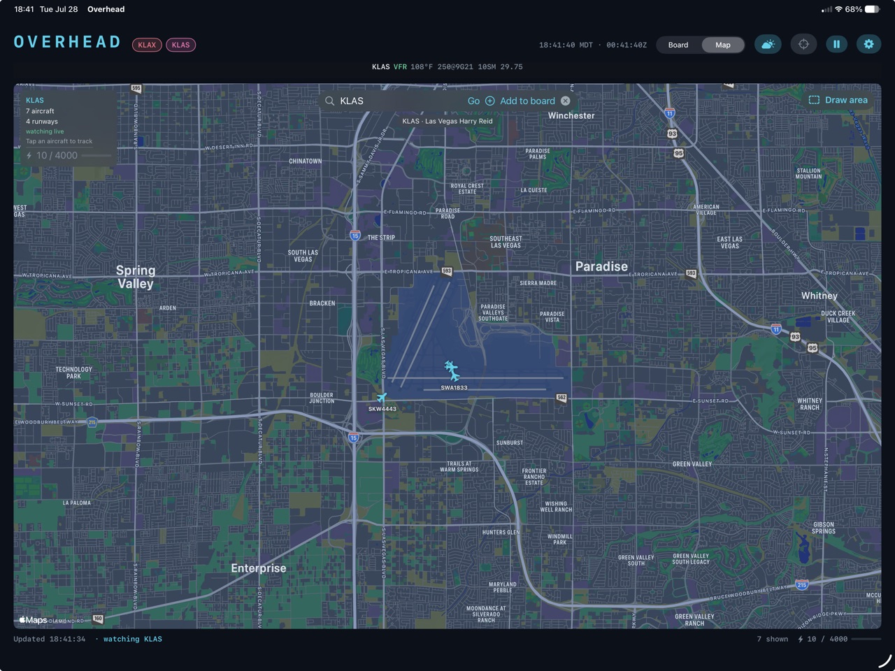 Overhead's map view centred on Las Vegas Harry Reid, showing aircraft icons on the airport surface with callsign labels and a panel reading 7 aircraft, 4 runways, watching live.
